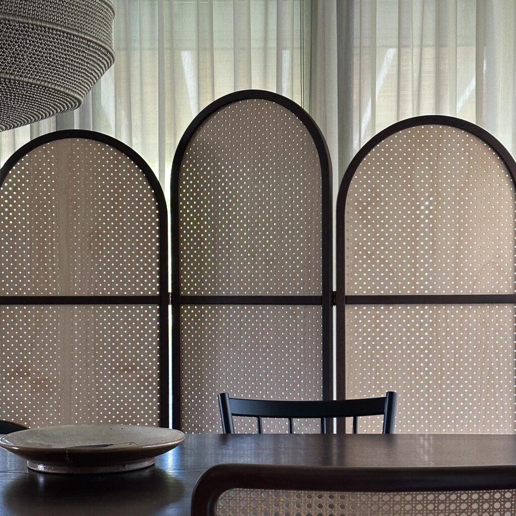 Arched Screens With Polka Dot Patterns In A Minimalist Interior Design Setting