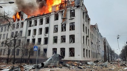 Burning Building Surrounded By Debris And Smoke