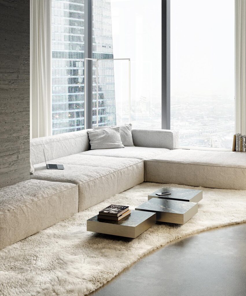 A Cozy Living Room With A Plush Sectional Sofa And A Modern Coffee Table In Front Of Large Windows Overlooking A Cityscape