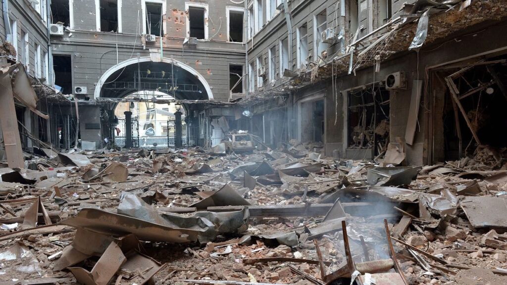 Damaged Building Interior with Debris and Broken Windows