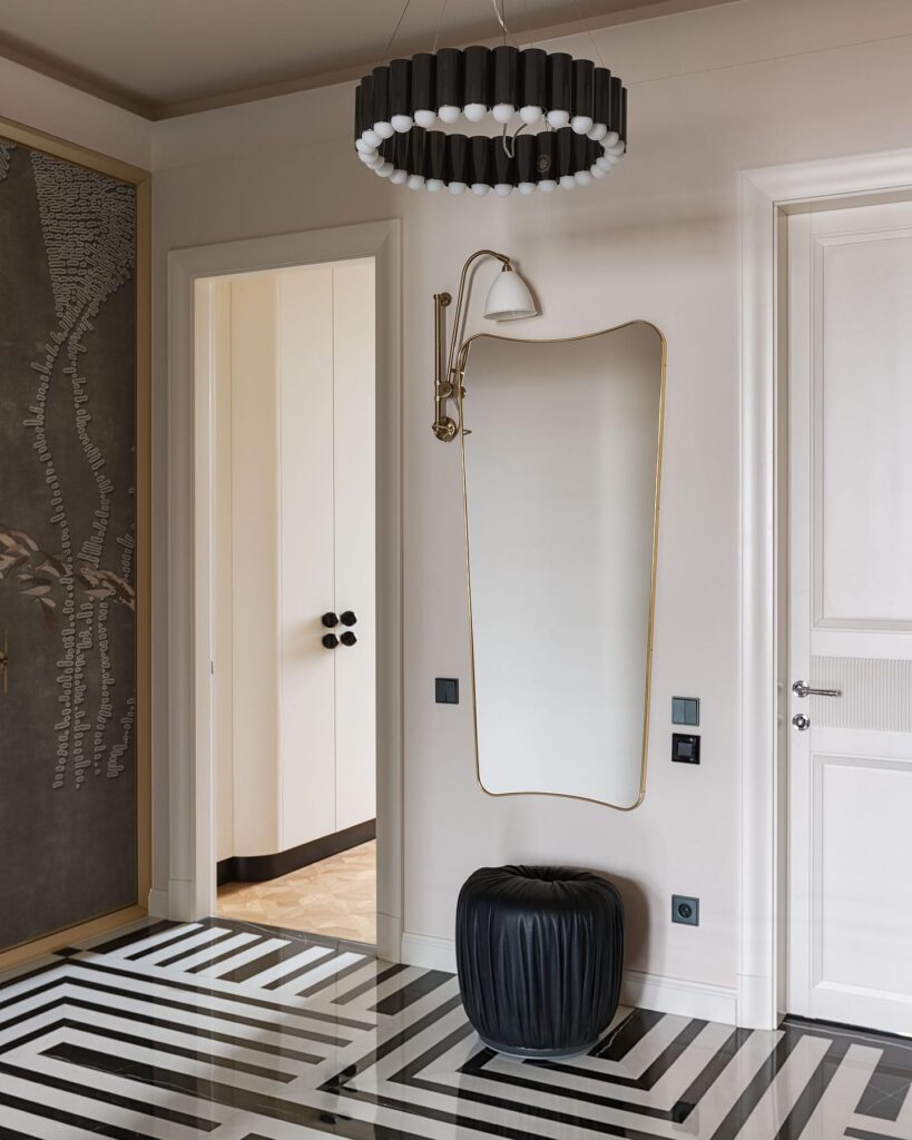 Elegant Entryway with Striking Chandelier and Geometric Flooring
