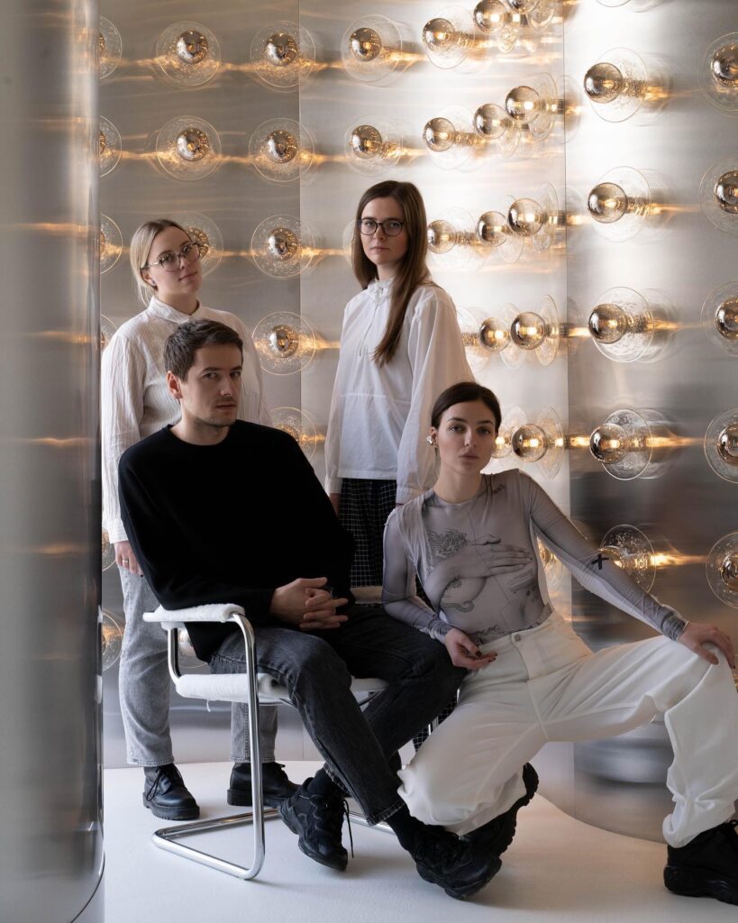 Glass Spheres Illuminate A Group Portrait In A Minimalist Interior Design Setting
