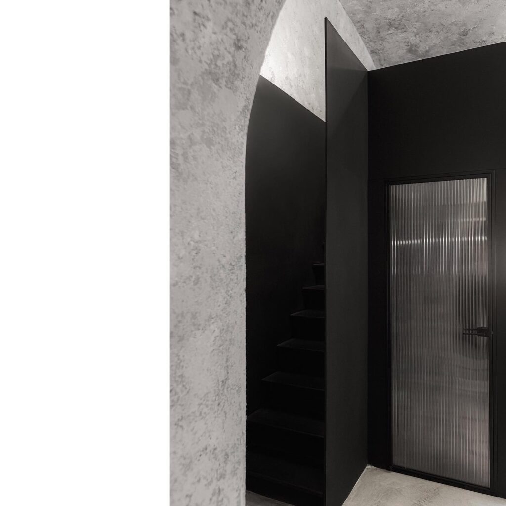 Minimalist Interior Design with Concrete Walls and Black Architectural Elements