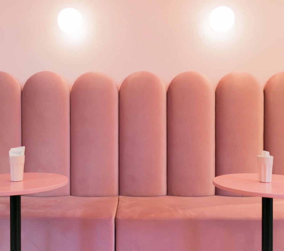 A Minimalist, Modern Interior Design With A Pink Sofa And Pastel Side Tables