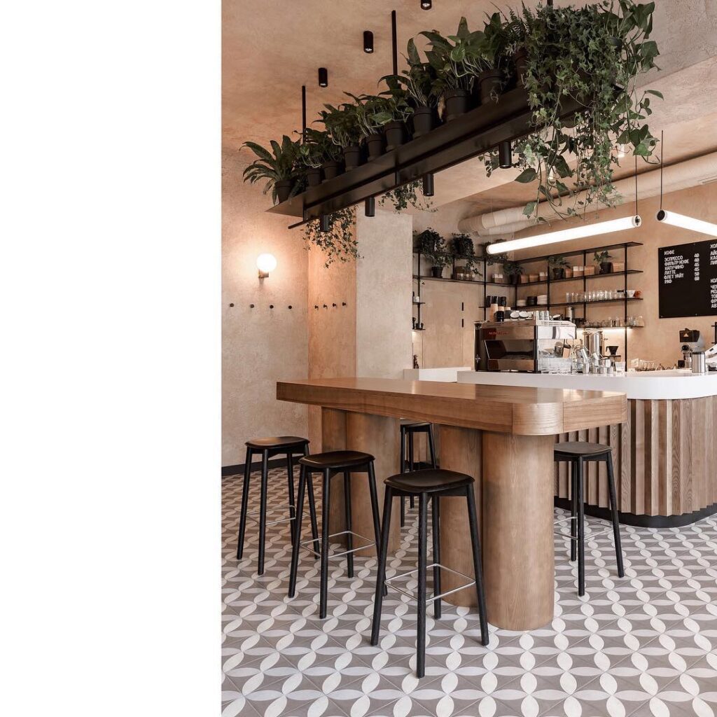 Modern Coffee Shop Interior with Hanging Plants and Patterned Tile Flooring