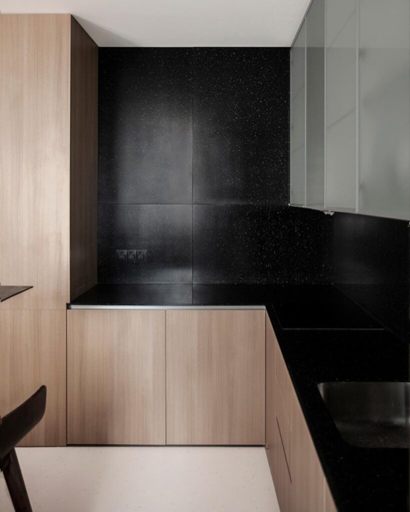 A Modern Kitchen Design with Sleek Black Cabinetry and Wooden Accents