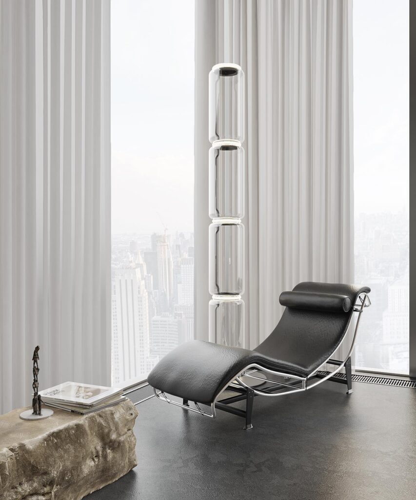 The Alt Text for the image is: A modern and minimalist interior design featuring a black leather chaise lounge chair positioned in front of a large window with a cityscape view. The room is decorated with a sculptural artwork and a stone side table. The overall design reflects the aesthetic of Sivak+Partners, a design studio known for their sophisticated and innovative approach to interior and exterior design.