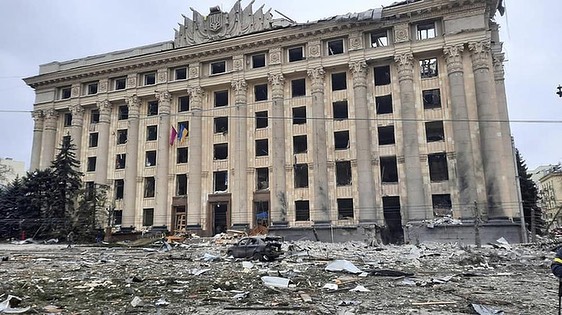 Ornate building amidst debris and destruction, showcasing impact of conflict on built environment