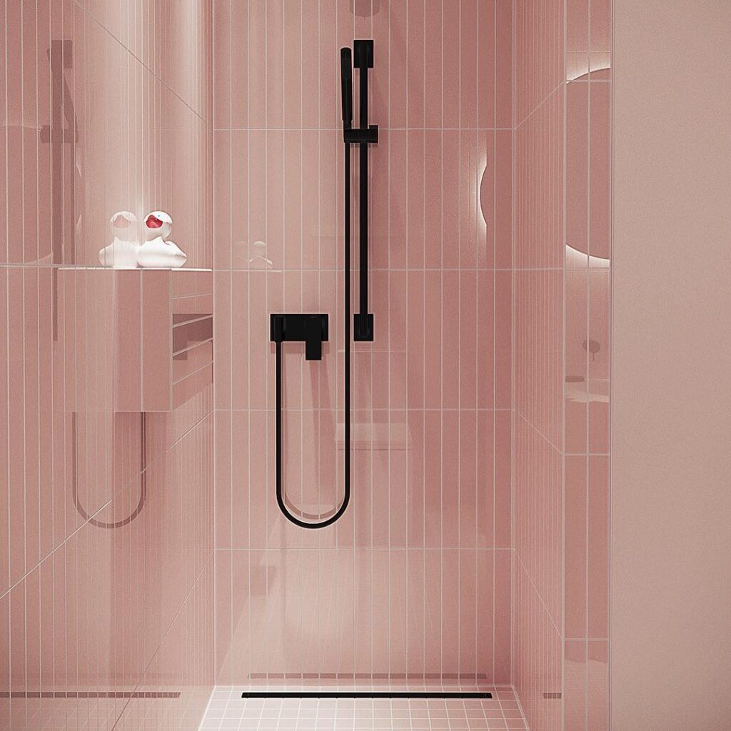 A Sleek Bathroom Design With Pink Tile Walls And A Black Shower Fixture