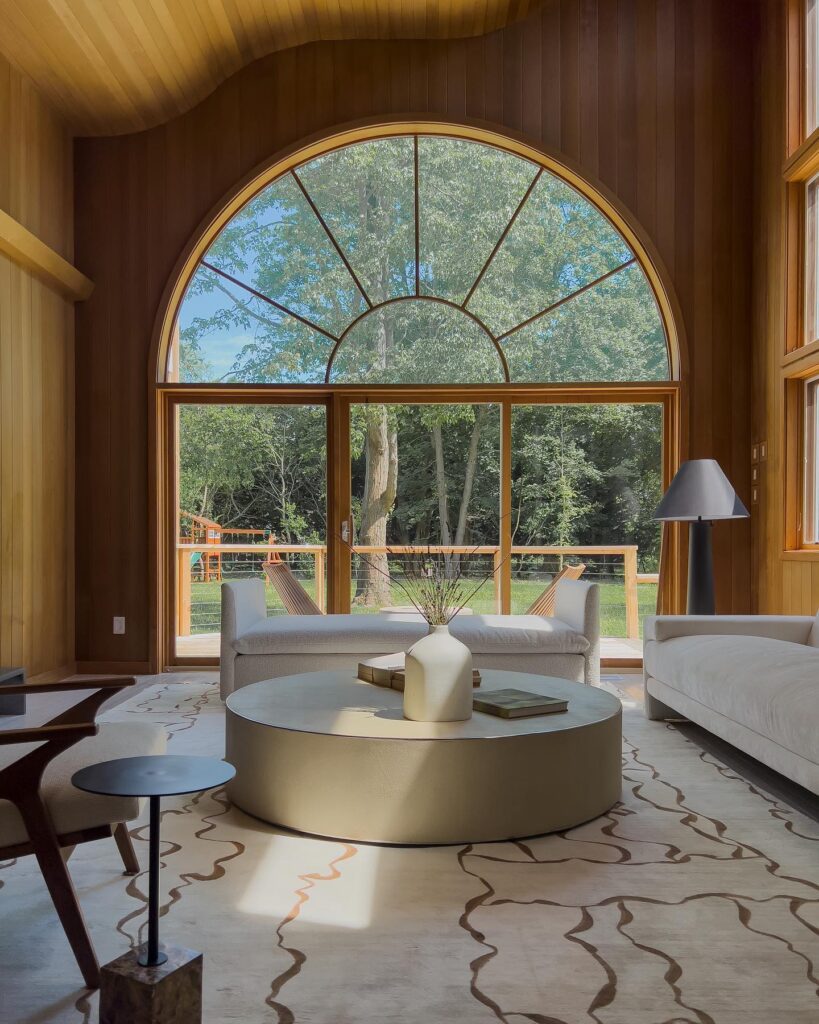 Serene Interior Design with Arched Window Overlooking Nature