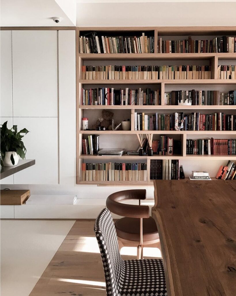 A Bookshelf Filled With Books In A Modern Home Interior
