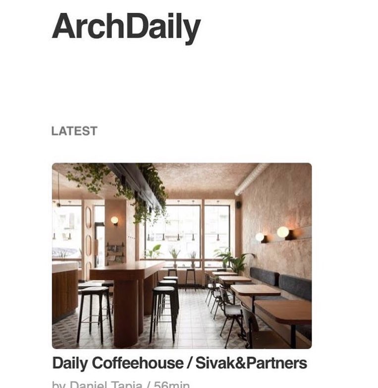 Cozy Interior of a Modern Coffee Shop with Wooden Furniture, Natural Lighting, and Potted Plants