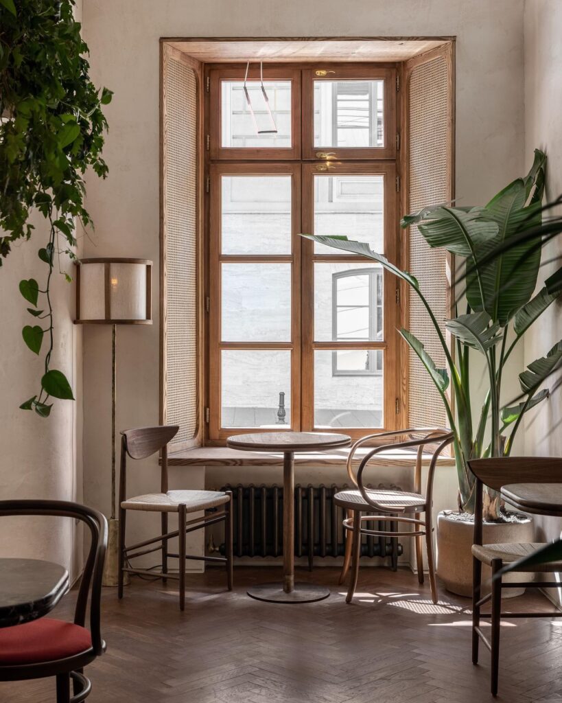 A Cozy Interior Design Space with Wooden Furniture and Large Windows