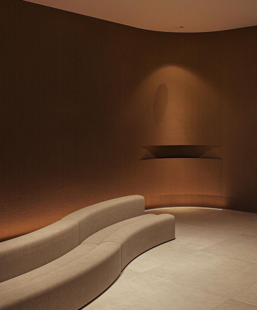 Curved Sofa And Lighting Fixture In Warm-Toned Interior Design Space