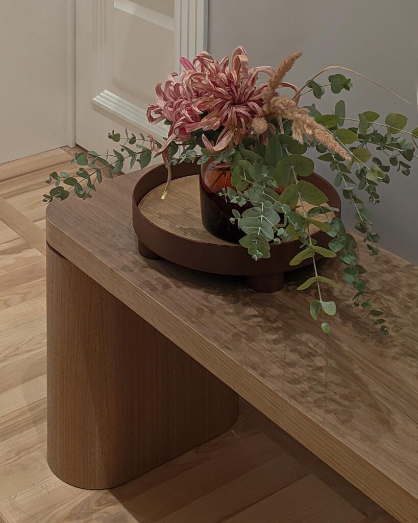 Decorative Floral Arrangement In A Wooden Bowl On A Wooden Table