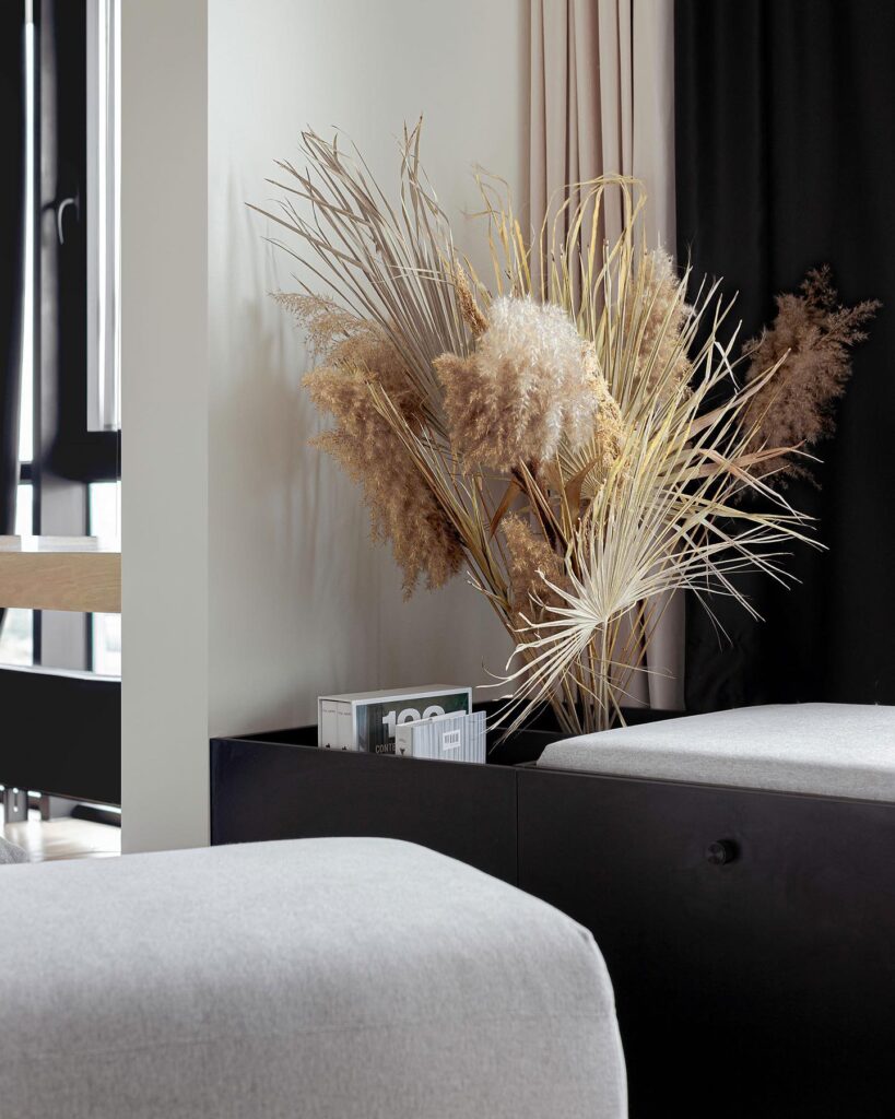 Decorative Floral Arrangement On Bedside Table In Modern Bedroom Interior