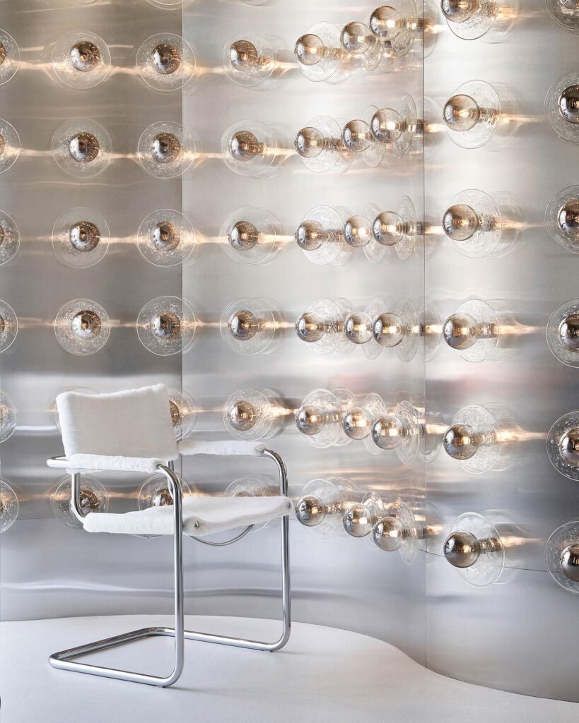 Illuminated Glass Spheres And White Upholstered Chair In Modern Interior Design