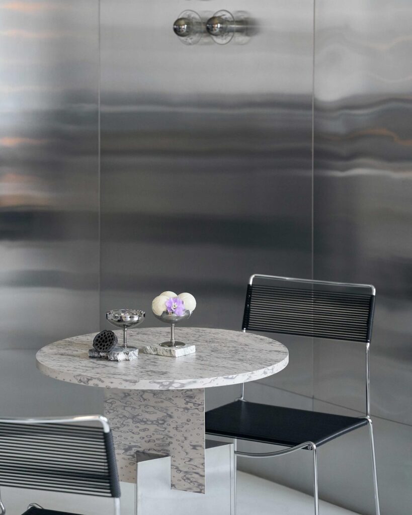 Marble-topped Table With Decorative Accents In A Modern Interior Design Setting