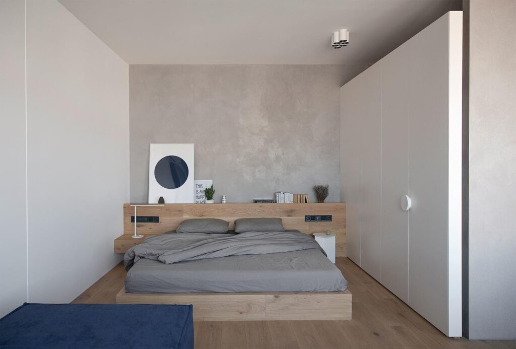 Minimalist Bedroom Design with Concrete Walls and Wooden Furnishings