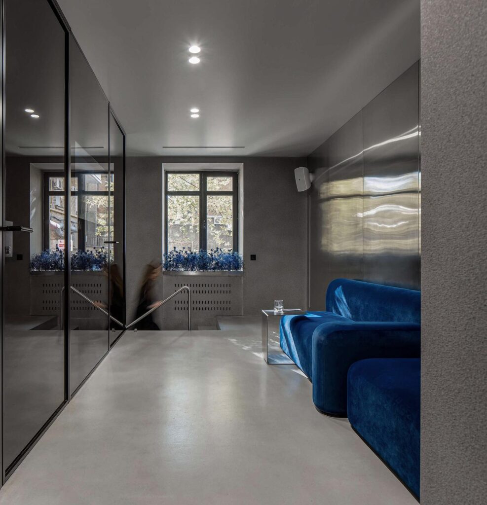 Minimalist Interior Design with Bright Natural Lighting and Vibrant Blue Sofa