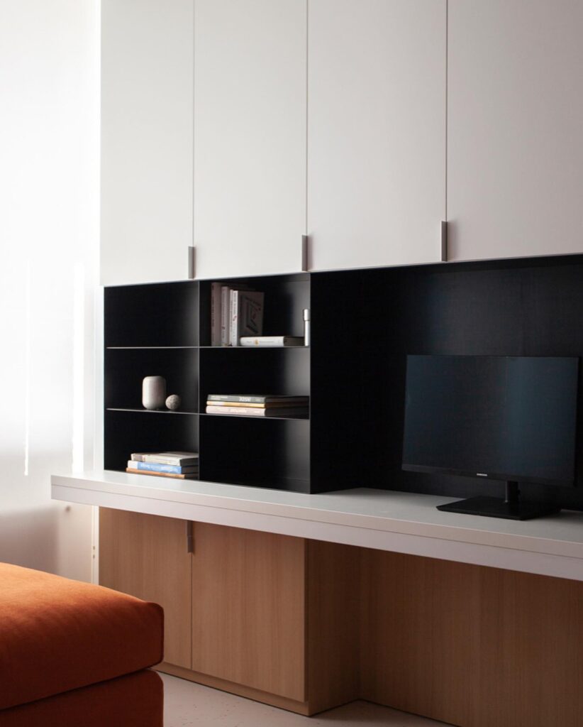Modern Entertainment Unit With Black Shelving and Wooden Cabinets
