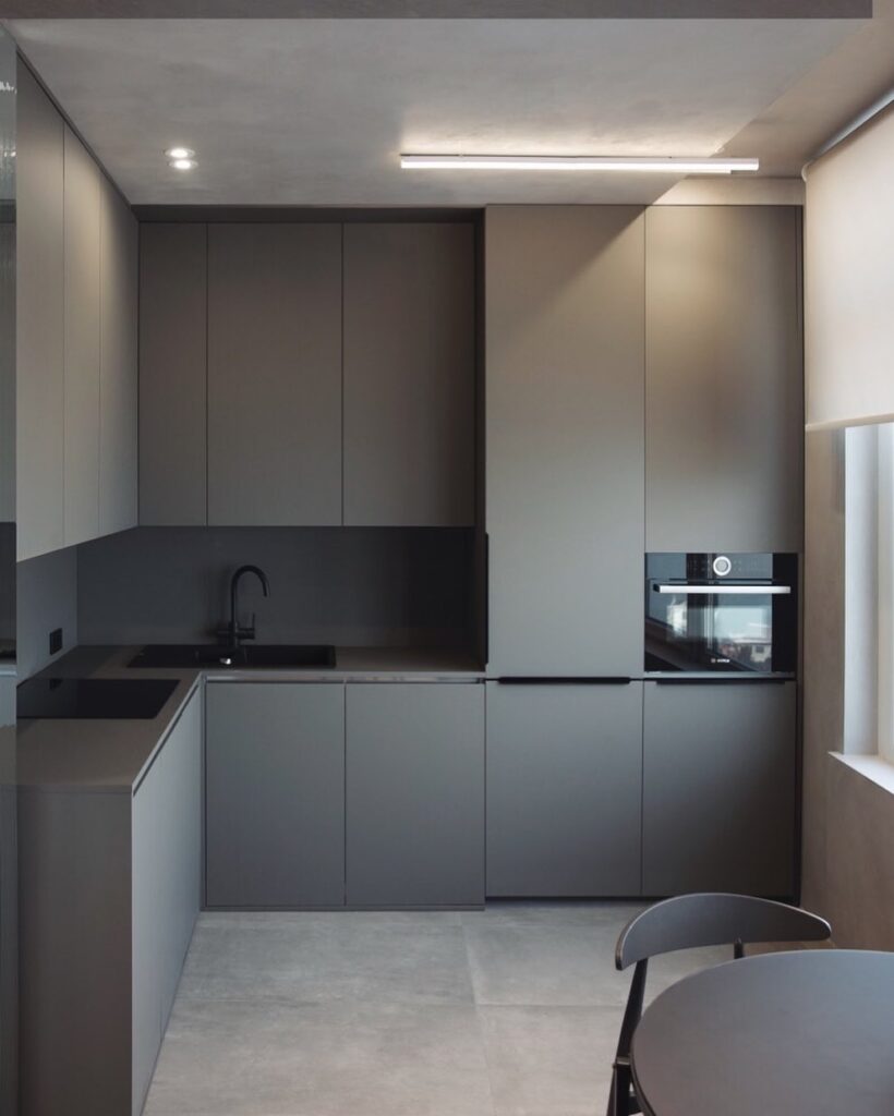 Modern kitchen interior with sleek gray cabinetry and appliances designed by Sivak+Partners