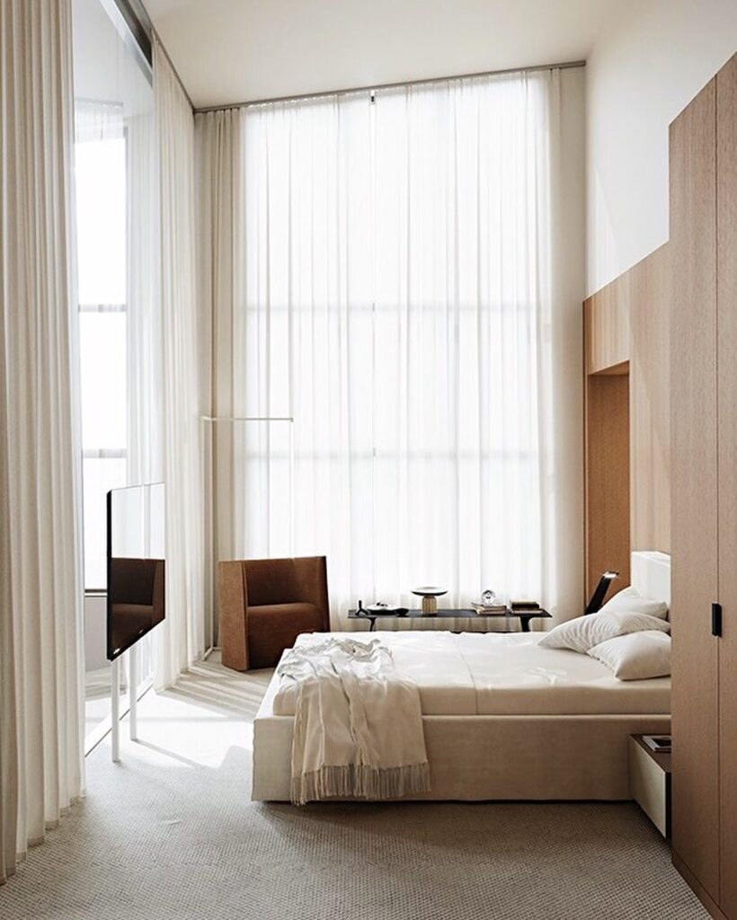 Spacious Bedroom Design With Floor-to-Ceiling Windows, Neutral Color Palette, and Minimalist Furniture